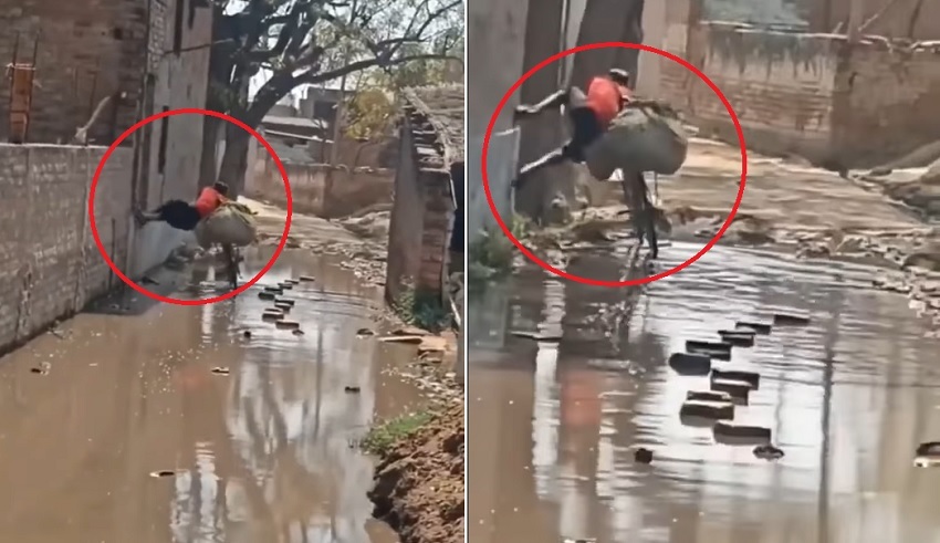 Chàng trai dắt xe đạp vượt qua con đường ngập nước kiểu 'người nhện' khiến dân mạng trầm trồ